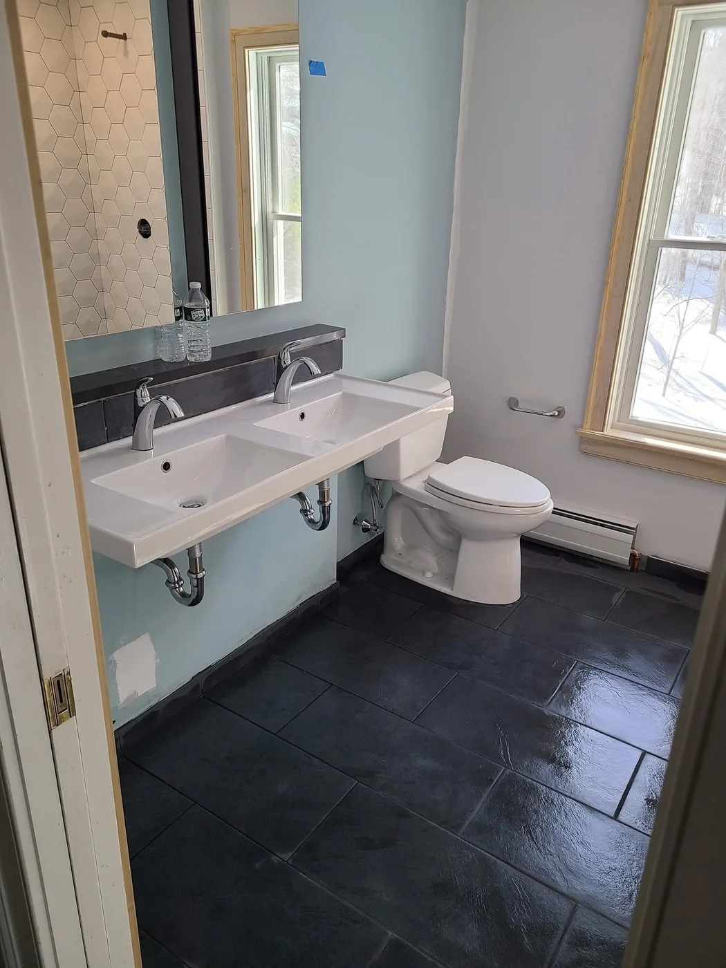 Full bathroom remodel with a double trough vanity and dark tile floor, Upper Valley NH