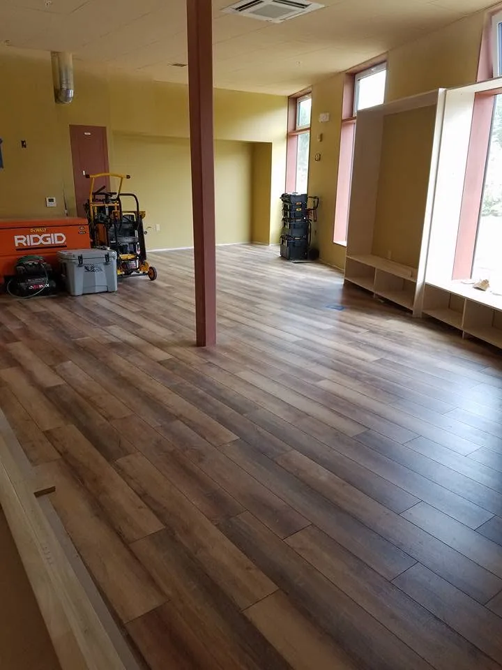 Newly refinished hardwood floors in a bright renovated open-plan room, Upper Valley NH