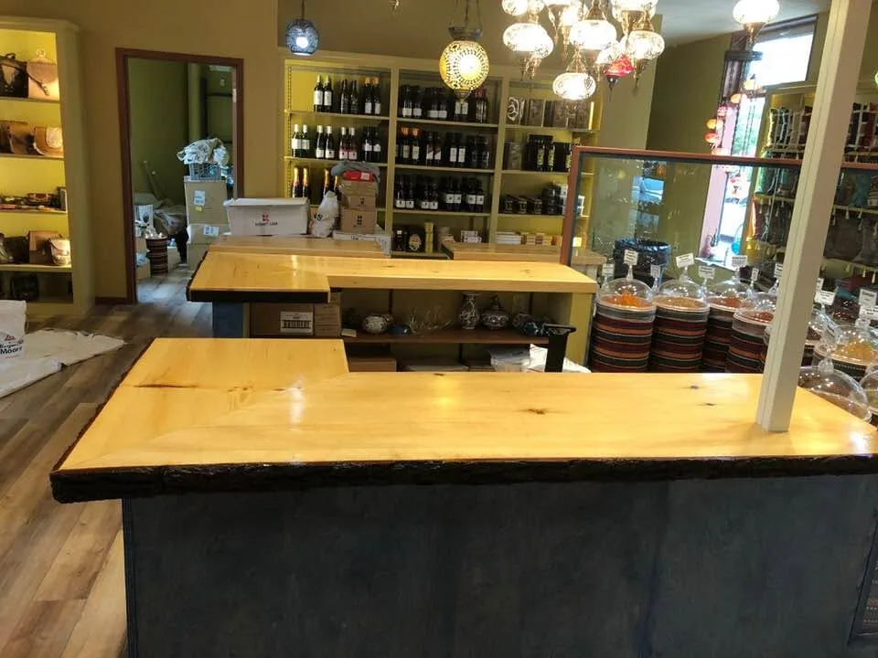 Custom live-edge wood counter with built-in wine storage, finish carpentry by MCS Contracting in the Upper Valley