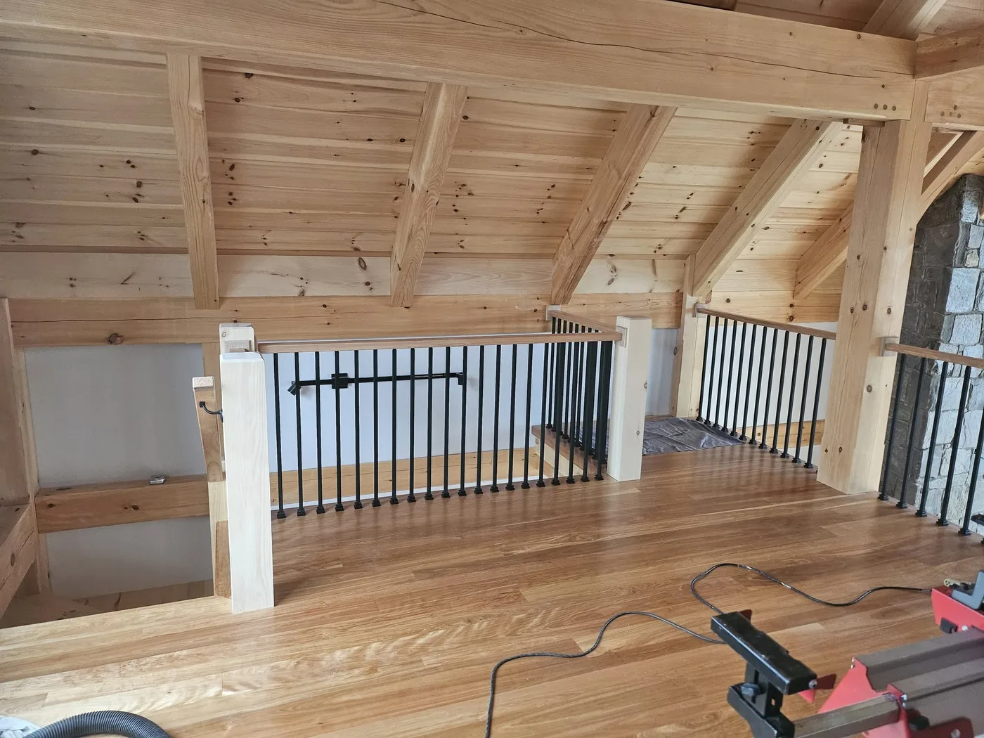 Timber-frame loft with a custom wood railing and pine ceiling, Upper Valley NH